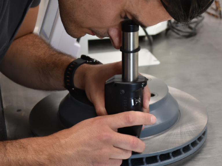 Quality inspection of a brake disc by an employee